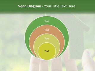 A Person Holding A Small Green House In Their Hands PowerPoint Template