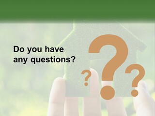 A Person Holding A Small Green House In Their Hands PowerPoint Template