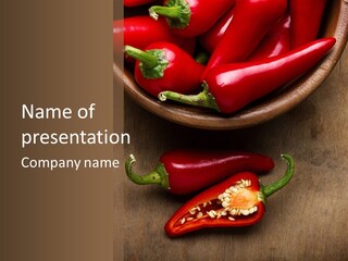 A Bowl Of Red Peppers On A Wooden Table PowerPoint Template