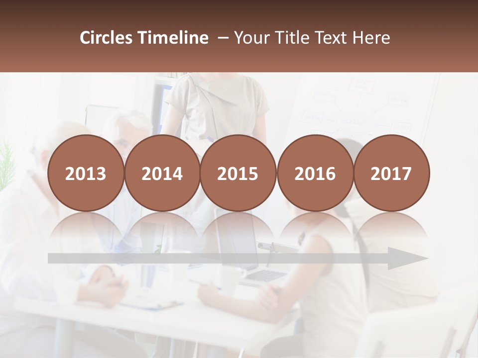 A Group Of People Sitting Around A Table PowerPoint Template