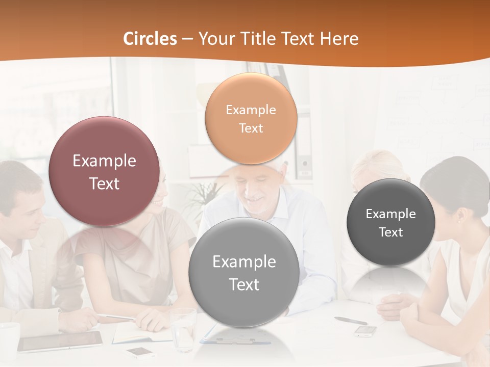 A Group Of People Sitting Around A Table PowerPoint Template