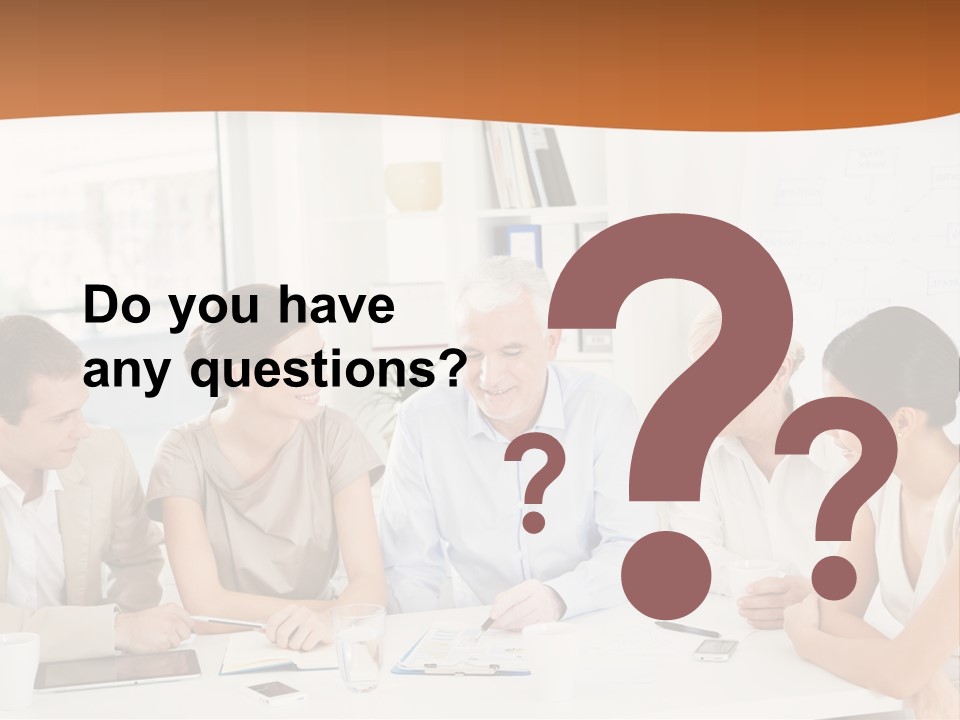 A Group Of People Sitting Around A Table PowerPoint Template