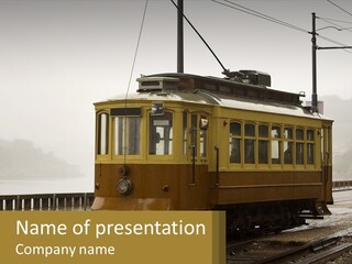 A Yellow Trolley Car On A Train Track PowerPoint Template