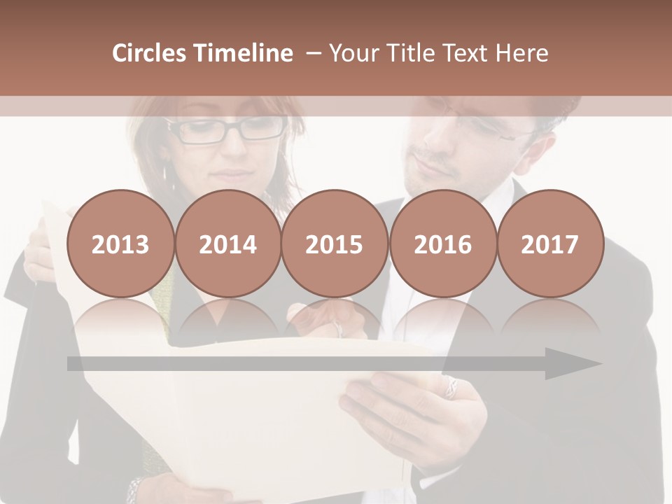 A Man And Woman Looking At A Piece Of Paper PowerPoint Template