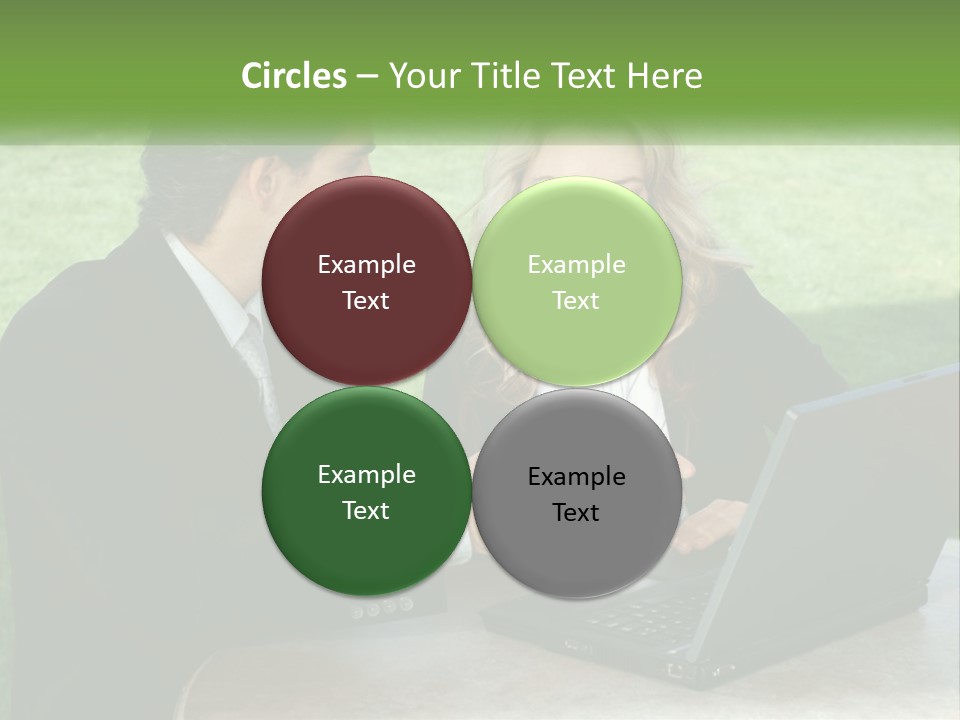 A Man And Woman Sitting At A Table Looking At A Laptop PowerPoint Template