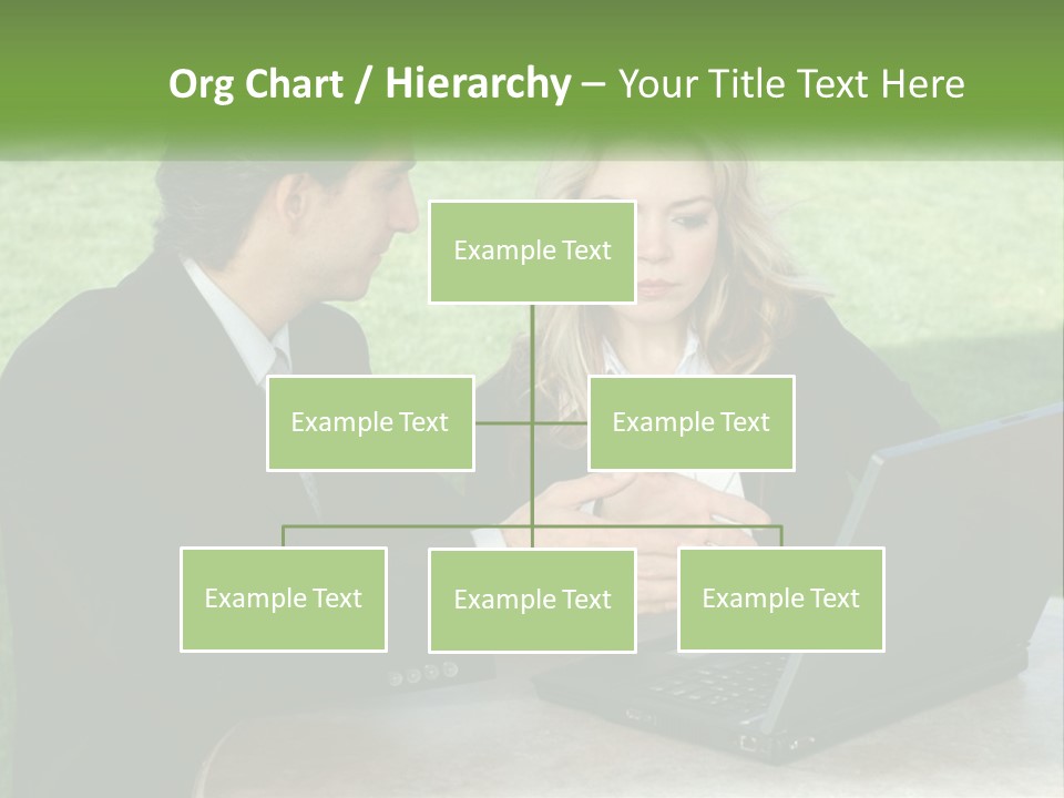 A Man And Woman Sitting At A Table Looking At A Laptop PowerPoint Template