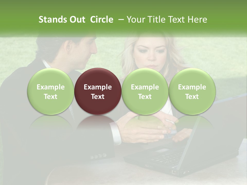 A Man And Woman Sitting At A Table Looking At A Laptop PowerPoint Template