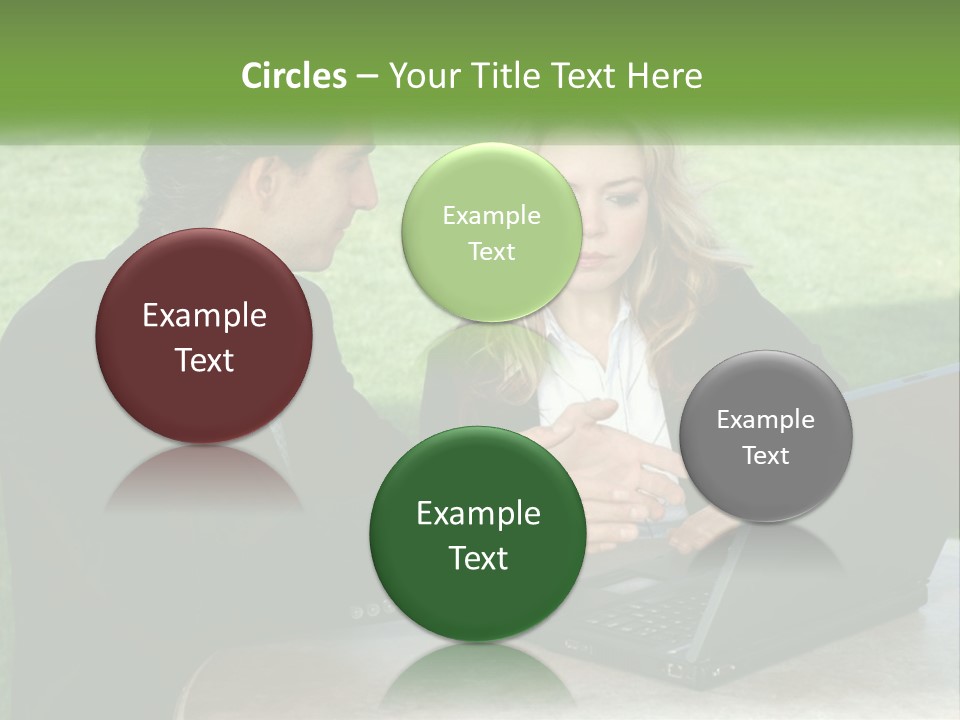 A Man And Woman Sitting At A Table Looking At A Laptop PowerPoint Template