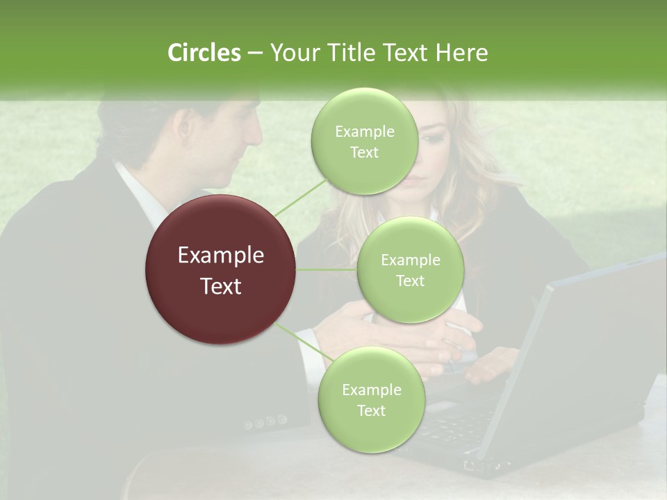 A Man And Woman Sitting At A Table Looking At A Laptop PowerPoint Template