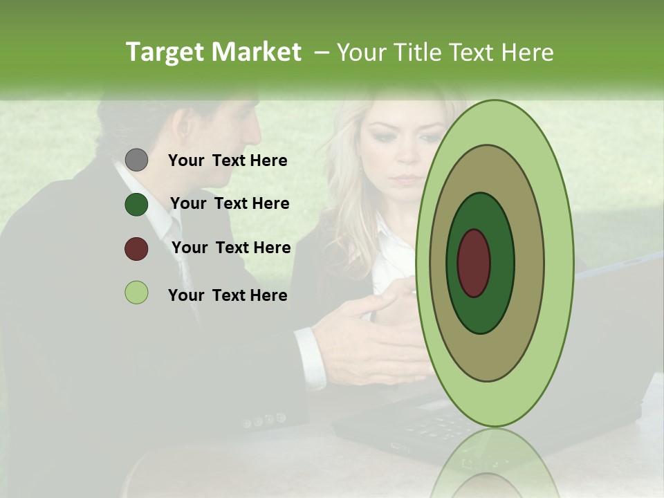 A Man And Woman Sitting At A Table Looking At A Laptop PowerPoint Template