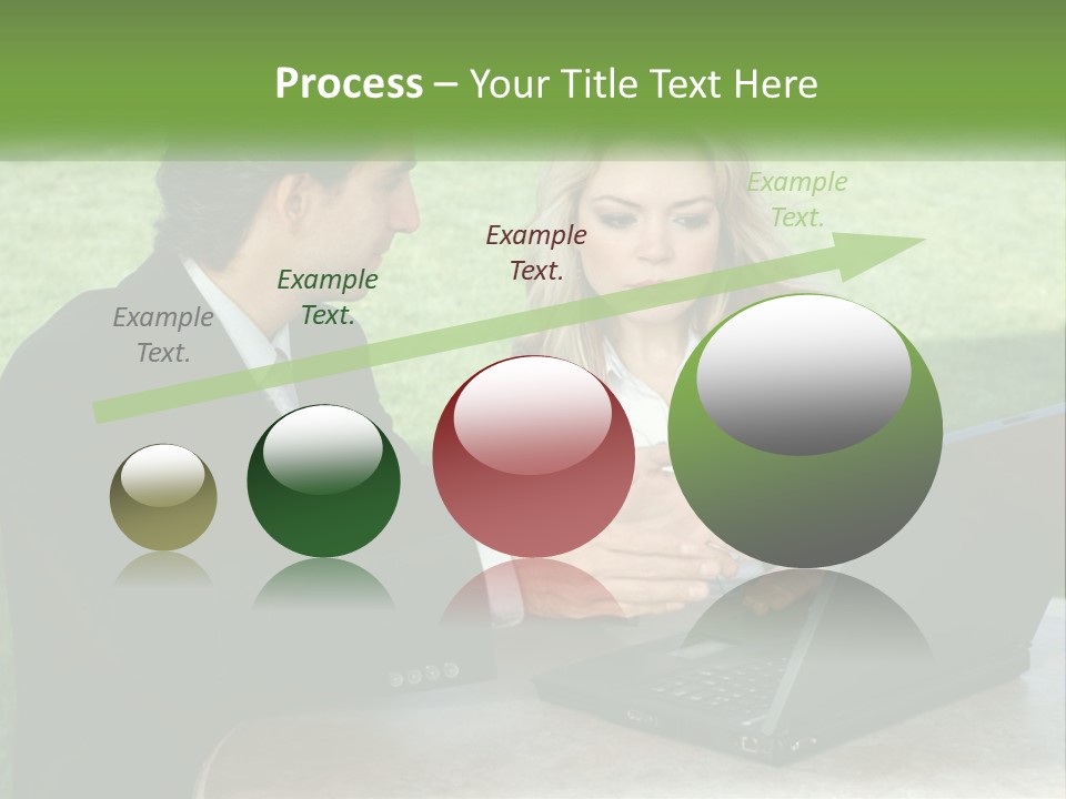 A Man And Woman Sitting At A Table Looking At A Laptop PowerPoint Template