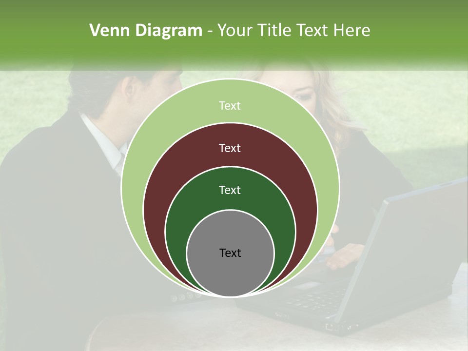 A Man And Woman Sitting At A Table Looking At A Laptop PowerPoint Template