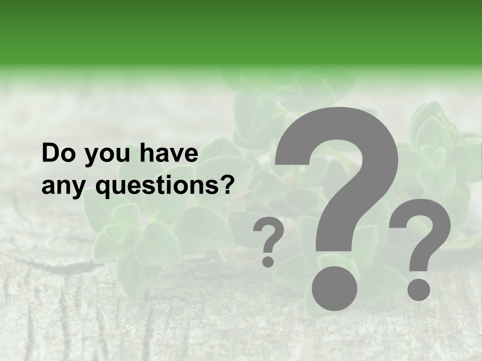 A Bunch Of Green Leaves Sitting On Top Of A Wooden Table PowerPoint Template