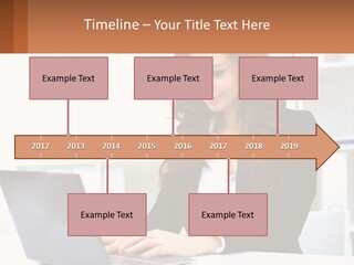 A Woman Sitting At A Desk With A Laptop PowerPoint Template