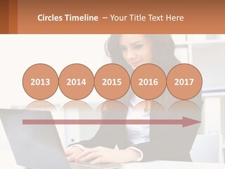 A Woman Sitting At A Desk With A Laptop PowerPoint Template