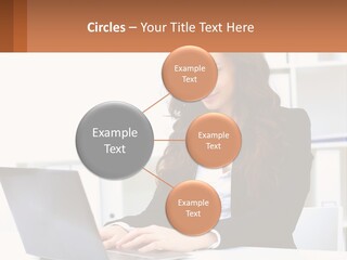 A Woman Sitting At A Desk With A Laptop PowerPoint Template