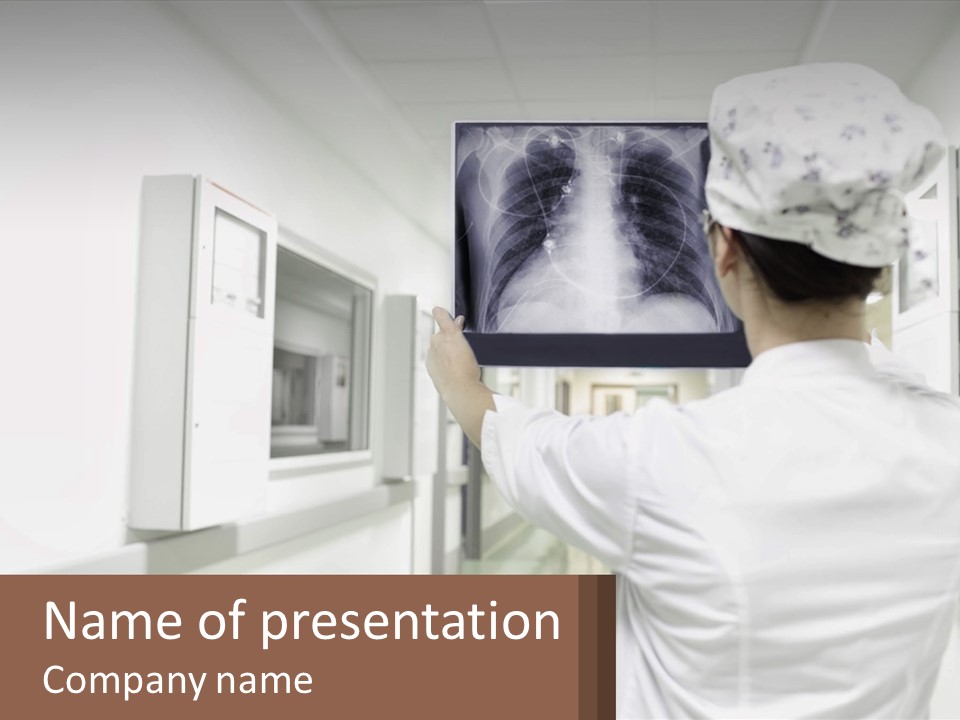 A Woman In A White Lab Coat Is Looking At A X - Ray PowerPoint Template