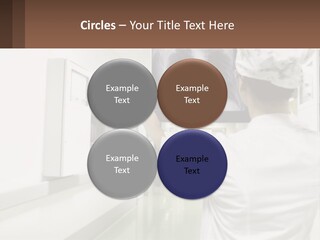 A Woman In A White Lab Coat Is Looking At A X - Ray PowerPoint Template