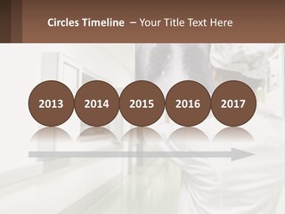 A Woman In A White Lab Coat Is Looking At A X - Ray PowerPoint Template