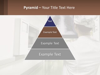 A Woman In A White Lab Coat Is Looking At A X - Ray PowerPoint Template