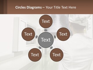 A Woman In A White Lab Coat Is Looking At A X - Ray PowerPoint Template