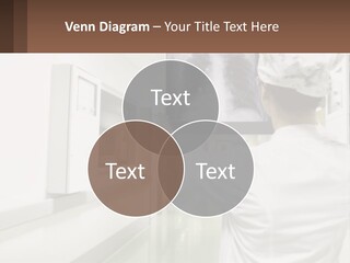 A Woman In A White Lab Coat Is Looking At A X - Ray PowerPoint Template