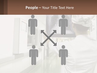 A Woman In A White Lab Coat Is Looking At A X - Ray PowerPoint Template