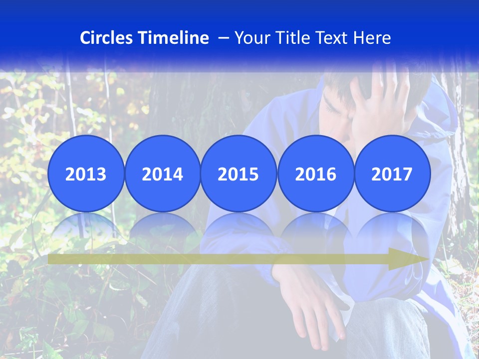 A Man In A Blue Jacket Sitting Next To A Tree PowerPoint Template