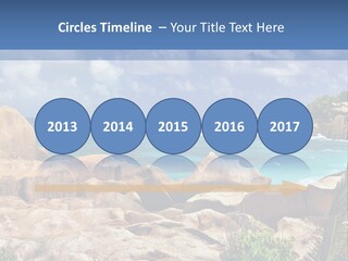 A Rocky Beach With Blue Water And White Clouds PowerPoint Template