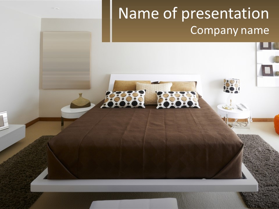 A Bedroom With A Large Bed And A Brown Blanket PowerPoint Template