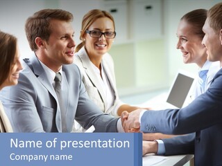 A Group Of Business People Shaking Hands Over A Table PowerPoint Template