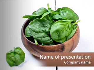 A Wooden Bowl Filled With Green Spinach Leaves PowerPoint Template