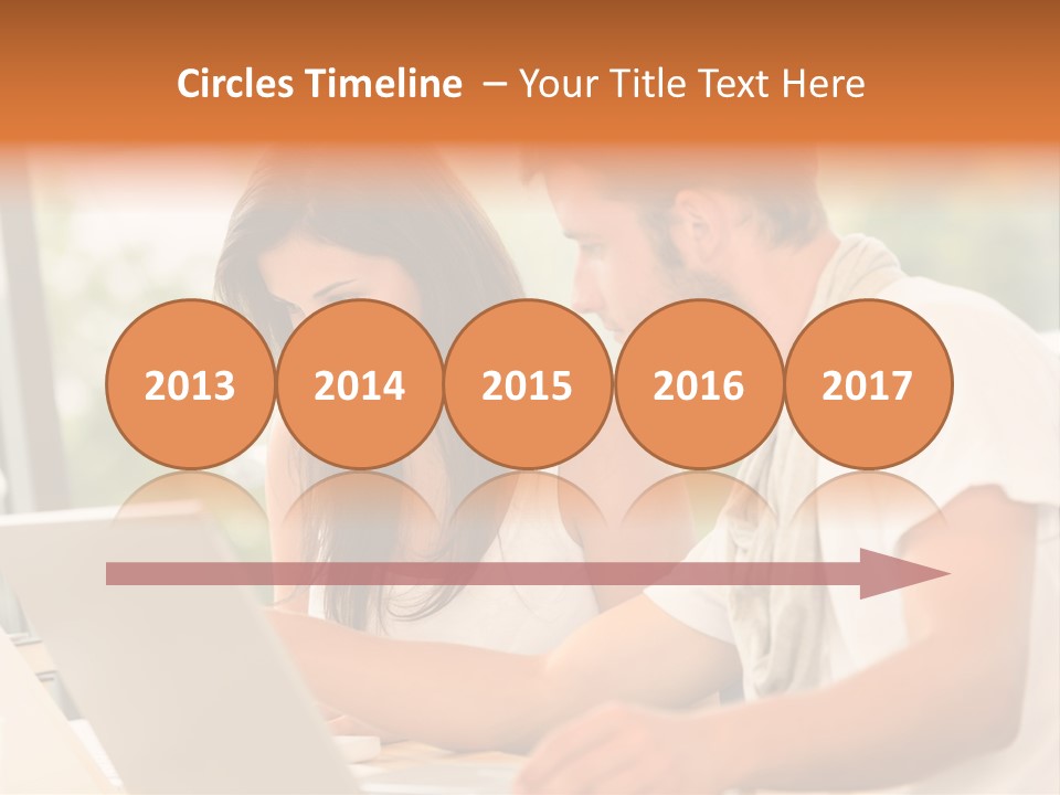 A Man And A Woman Are Looking At A Laptop PowerPoint Template