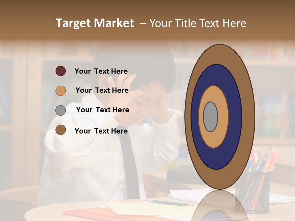 A Young Boy Sitting At A Desk In Front Of A Book Shelf PowerPoint Template