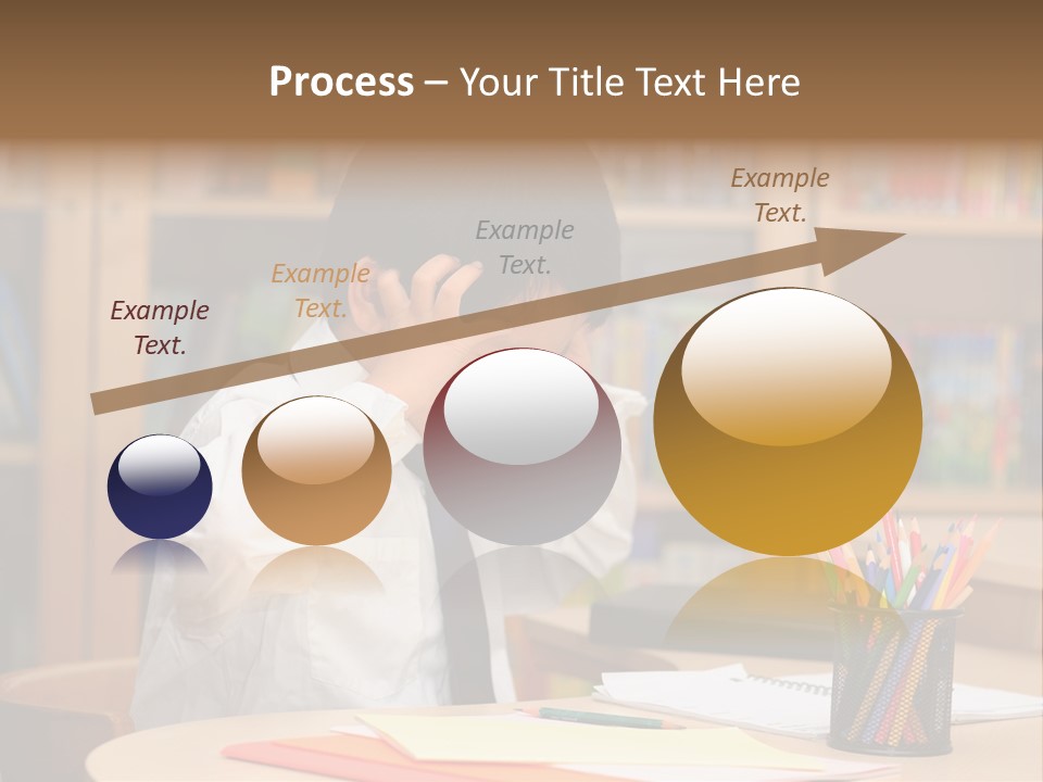 A Young Boy Sitting At A Desk In Front Of A Book Shelf PowerPoint Template