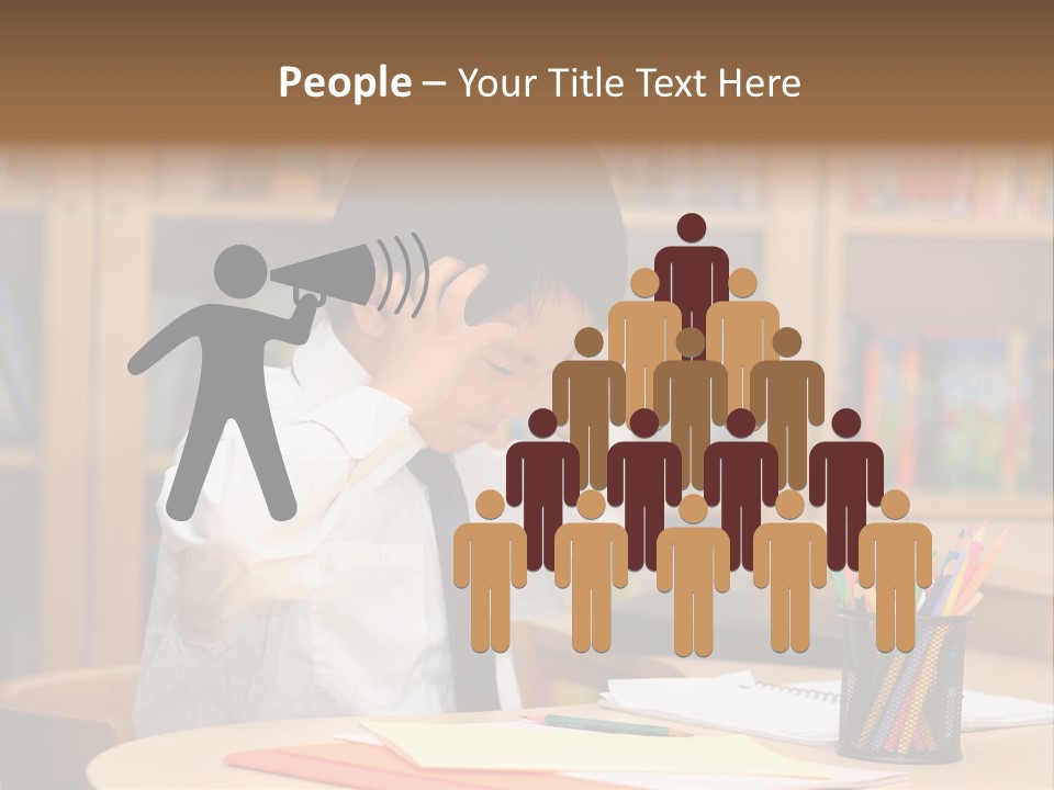 A Young Boy Sitting At A Desk In Front Of A Book Shelf PowerPoint Template