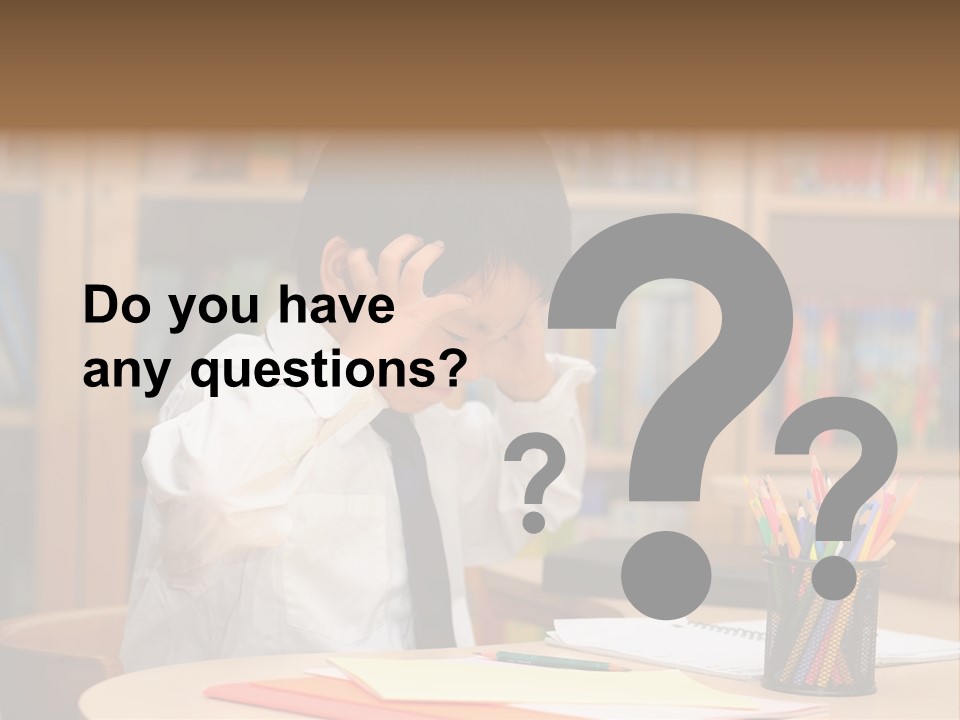 A Young Boy Sitting At A Desk In Front Of A Book Shelf PowerPoint Template