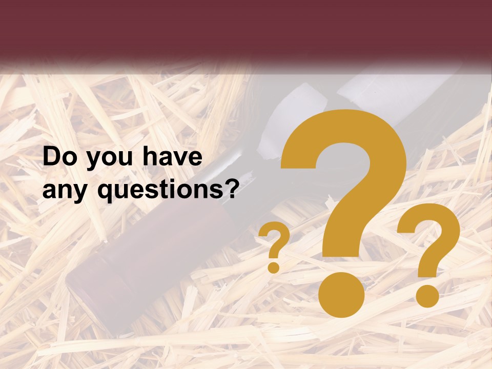 A Bottle Of Wine Sitting On Top Of Straw PowerPoint Template