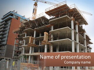 A Large Building With A Crane On Top Of It PowerPoint Template