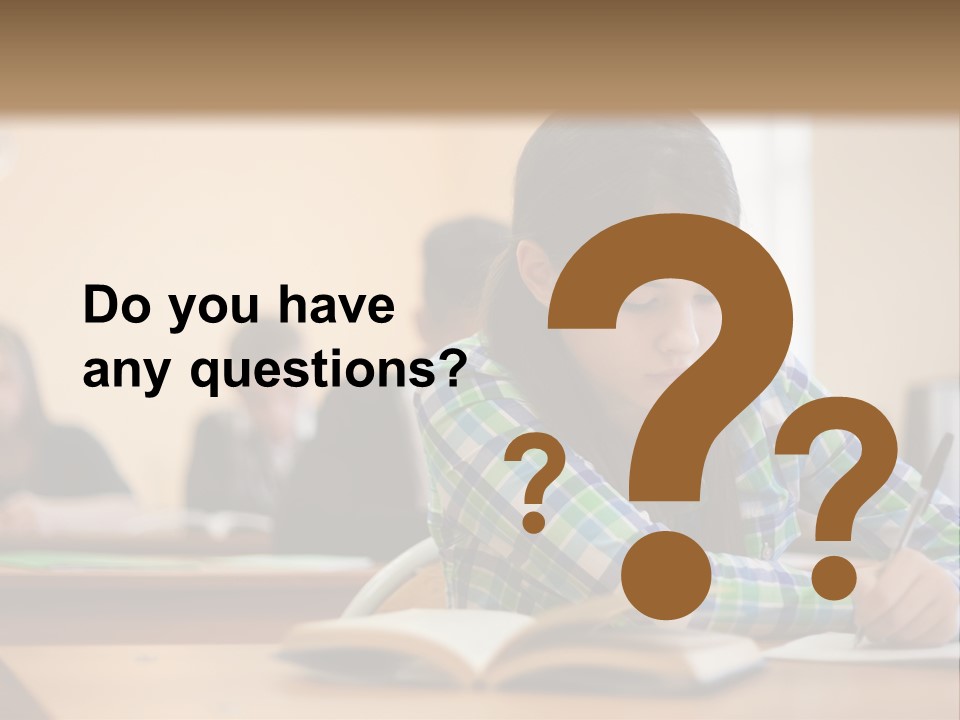 A Young Girl Sitting At A Desk With A Book In Front Of Her PowerPoint Template