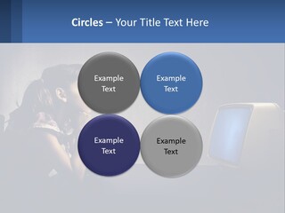 A Little Girl Sitting In Front Of A Computer PowerPoint Template