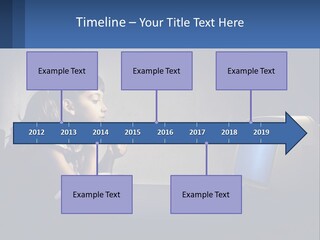 A Little Girl Sitting In Front Of A Computer PowerPoint Template