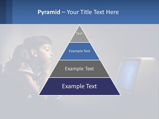 A Little Girl Sitting In Front Of A Computer PowerPoint Template