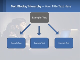 A Little Girl Sitting In Front Of A Computer PowerPoint Template
