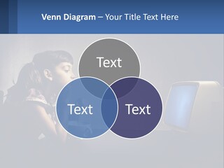 A Little Girl Sitting In Front Of A Computer PowerPoint Template