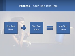 A Little Girl Sitting In Front Of A Computer PowerPoint Template