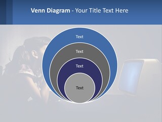 A Little Girl Sitting In Front Of A Computer PowerPoint Template