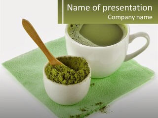 A Cup Of Green Tea Next To A Spoon PowerPoint Template