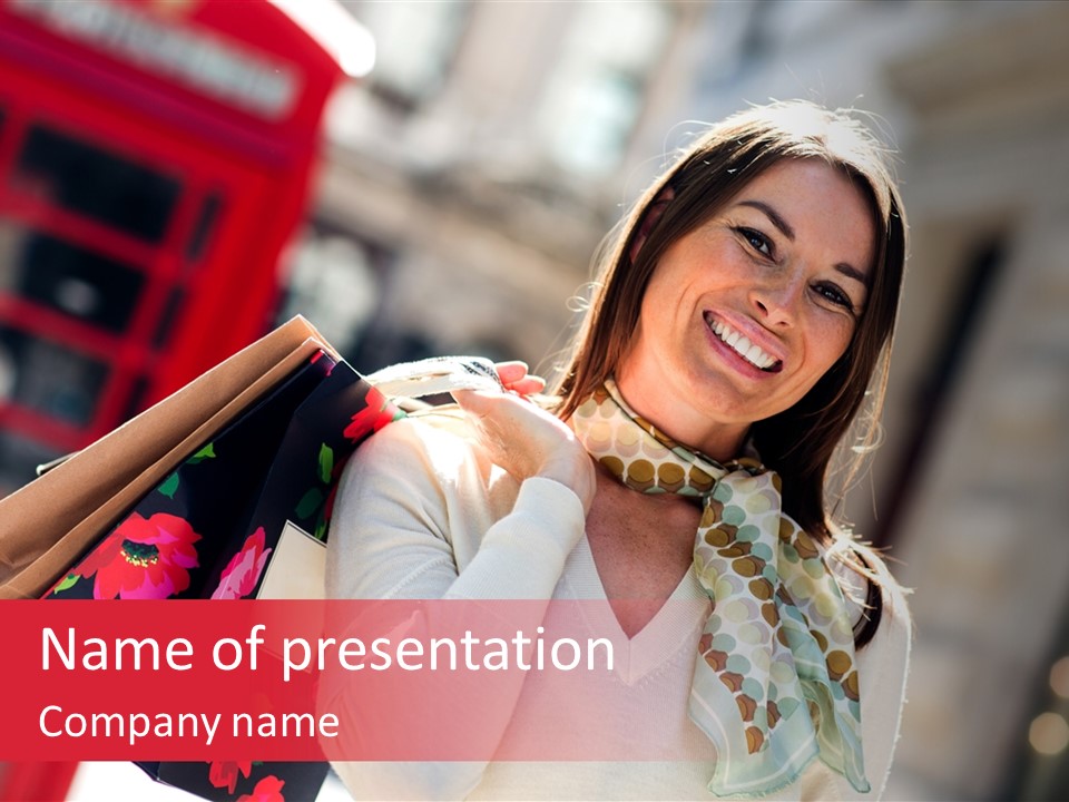 A Woman Carrying Shopping Bags And A Red Telephone Booth PowerPoint Template