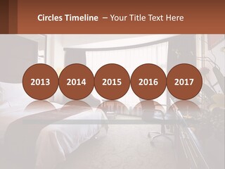 A Bed Room With A Neatly Made Bed And A Chair PowerPoint Template